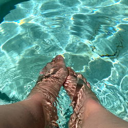 Peeking into the swimming pool with bare feet