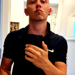 Man taking a selfie in bathroom mirror