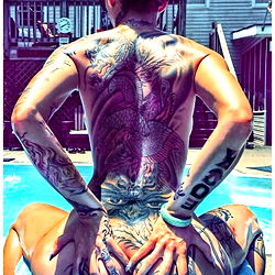 Iambellabellz on a pool lounger with a tattooed back