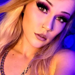 Amber Rae, an OnlyFans model from Florida captures attention in this vibrant image with striking makeup and confident pose.