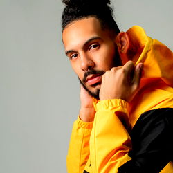 Stylish Model in Sporty Attire with Hooded Jacket and Bold Yellow Outfit