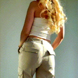 Fashionable Model in Tan Pants and White Tank Top