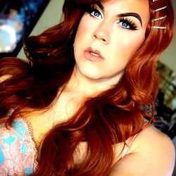 Pinup Peach, a stunning OnlyFans model with vibrant red hair and captivating eyes,