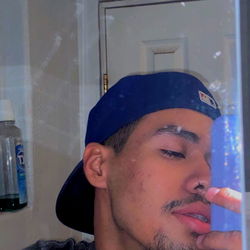 A Young Adult Man with a Beard in a Blue Cap