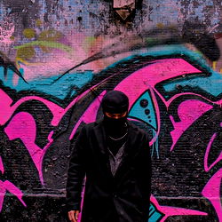Mysterious Street Artist in Graffiti-Laden Alley