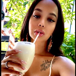 Sultry Instagram Model Queen Clara enjoying a frosty beverage at Miami Beach