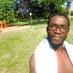 Shirtless Man in Towel, Park Awaits