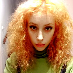 Naomi Gratz, Vivid Red Hair and Green Sweater