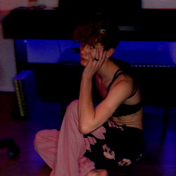 Ace, a musician lost in thought with a hand on the face