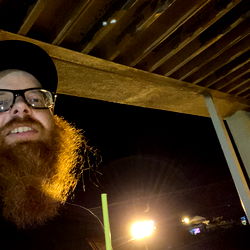 Awesome Guy in a Cap Sitting at an Outdoor Cafe