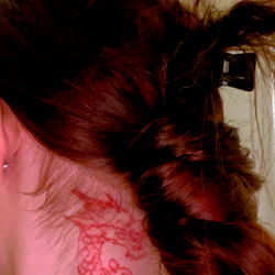 Monique's Stylish Updo with a Cute Dragon Tattoo on Her Neck