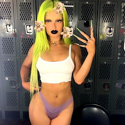 Vividly colored model with green hair and large eyes