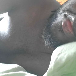 A Shirtless Man in a Bed