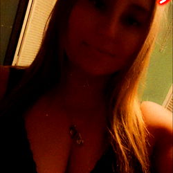 A woman posing for a selfie with OnlyFans name Thick momma