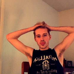 A Young Man in a Black Tank Top Resting His Head on His Hand