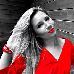 Blonde Model with Red Shirt Against Brick Wall