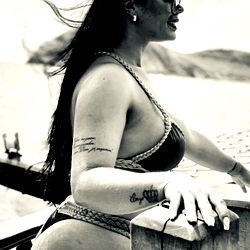 Bikini-clad model Luana strikes a pose by a boat