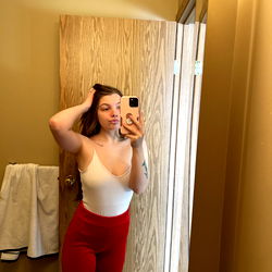 Model Dani Lynn Posing in Bathrobe, Red Pants, and No Shoes