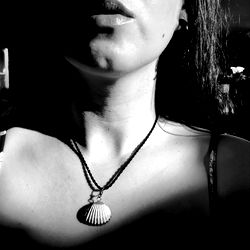 A woman with a necklace in the sunlight.