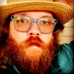 A Man in a Hat and Glasses