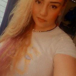 A young woman in a mirror selfie, taking a picture of herself. Onlyfans model TicklemePINK6404.