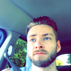 A Young Man Posing for a Selfie in His Car