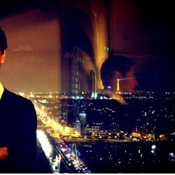 Man with a view of a cityscape at night