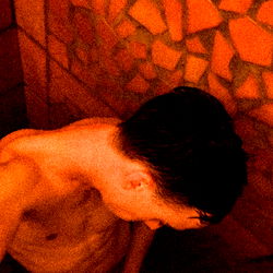 Intimate, Rustic Bathroom Scene with a Shirtless Man