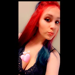 Haley, a 24-year-old OnlyFans model captures attention with her vibrant hair and confident pose.