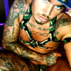 Tattooed Man in Camouflage Bikini Top