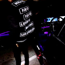 Cool and stylish model pose in a neon-lit car