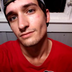 Snuffy, a young man with a tattoo peeking out from under his shirt.